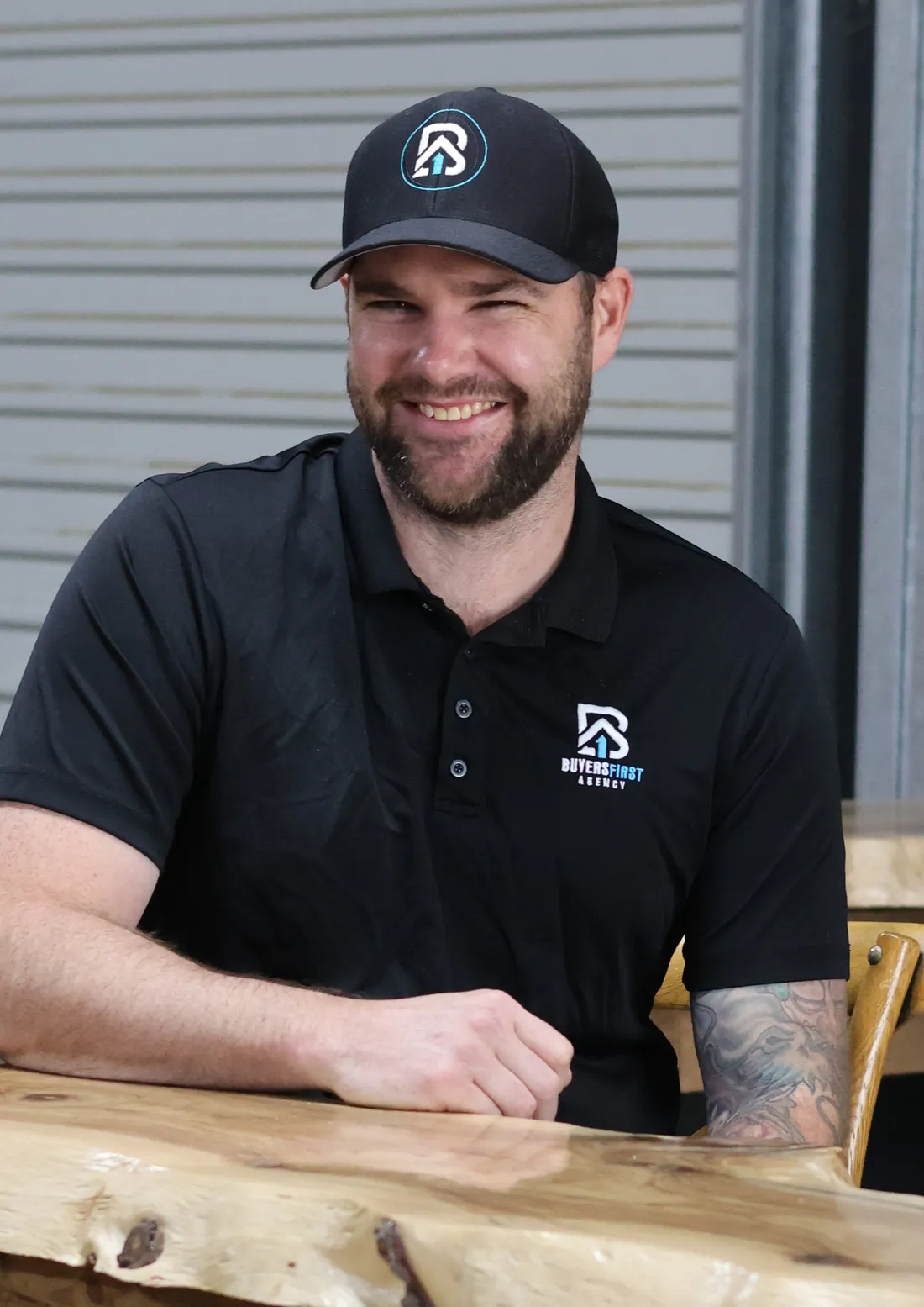 Dan White sitting at a timber table, ready for a chat